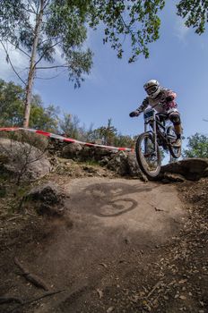 VIANA DO CASTELO, PORTUGAL - MAY 13: Borja Caneiro jump on rocky terrain on the 4th Stage of the Taca de Portugal Downhill Vodafone on may 13, 2012 in Viana do Castelo, Portugal.