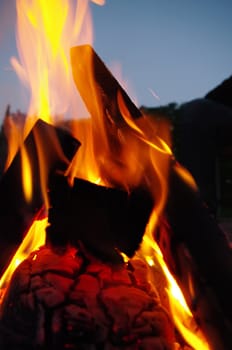 a nice campfire burning outside in summer