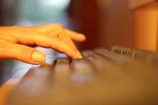 close up of woman hand on a computer keyboard