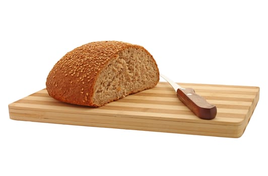 bran bread with knife on cutting board