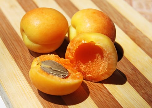 ripe apricots on a wooden board
