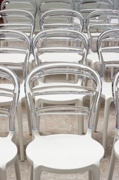 Close up of empty clear plastic chairs