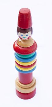 A vintage stacking toy, isolated on white, soft focus
