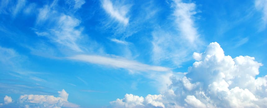 Blue sky background with tiny clouds