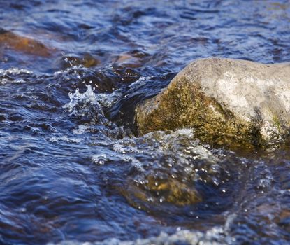 Moving water on a rock