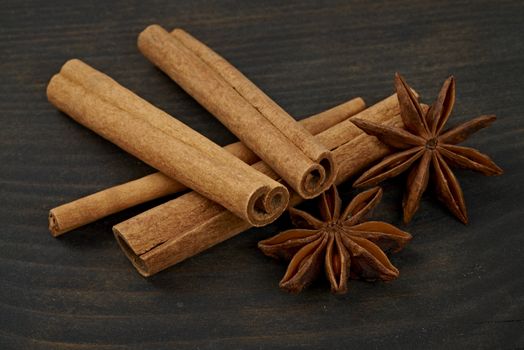 Cinnamon and star anise in an old wooden board. Close-up.