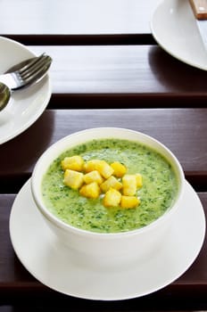 Spinach soup on the wooden table