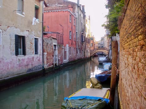 Boats tied alongside a quiet canal in Venice, Italy.