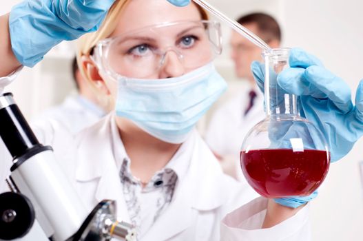 chemist working in the laboratory, mix liquid