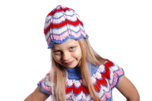 smiling little girl in knitted hat on a white background