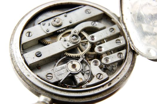 old silver pocket watch mechanism on white background