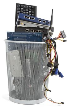 electronic scrap in trash can. keyboard, power supply, router, cables, logicboard, hard drive, switch