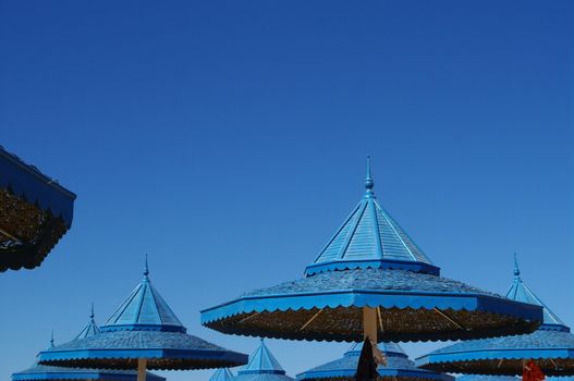 strow sun shade on a beach against blue sky