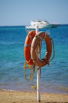 lifebelt on a beach in the background a boat