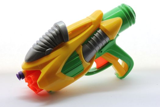 Yellow and green dart gun loaded with one purple dart.