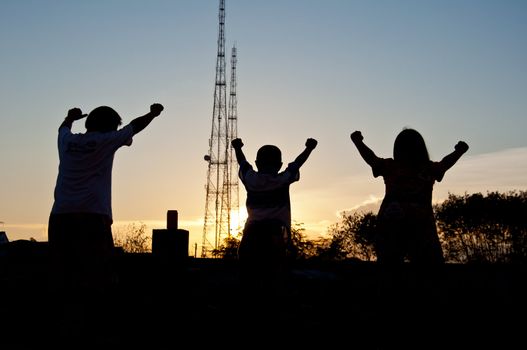 silhouette of children happy and victory