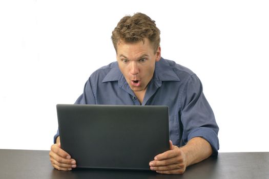 Man shocked at what he finds on laptop computer, isolated on white background