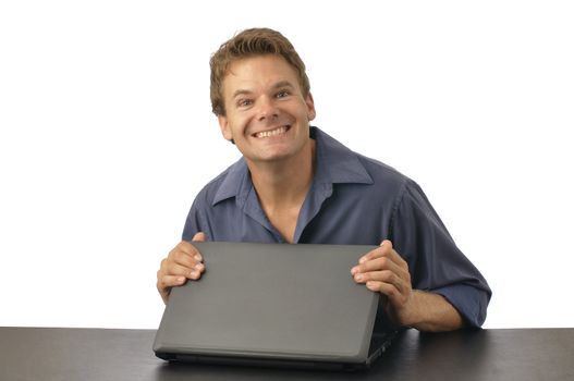 Man with guilty grin closes laptop computer