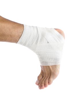 Ankle of male athlete wrapped in white bandages