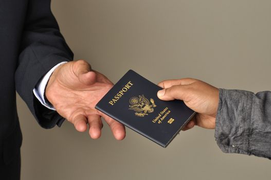 Closeup of woman's hand giving passport to man