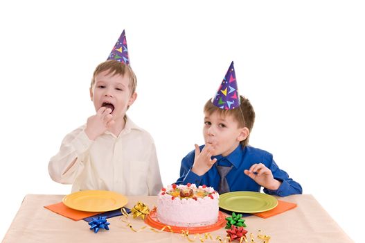 two boys eating a cake his hands isolated on white background