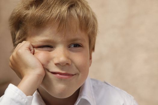 Portrait of the boy on a beige background