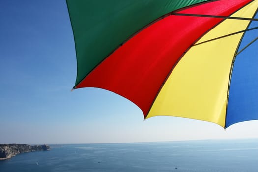 colorful parasol at the ocean on a sunny day