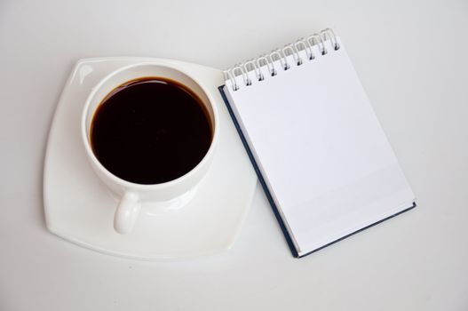 Blank paper and black coffee on white background