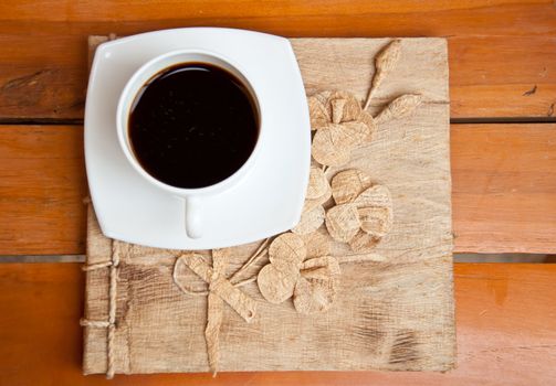 blank paper and black coffee on wood background