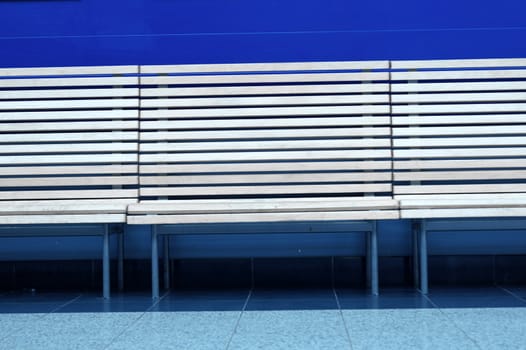 row of wooden benches on a blue background