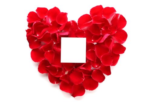 Beautiful heart of red rose petals with blank paper on the white background