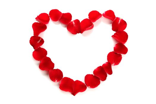 Beautiful heart of red rose petals on white background