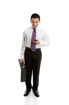 A businessman either making a phone call or reading or sending a sms text message, 