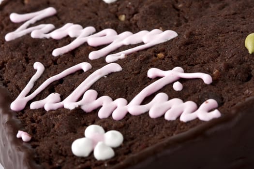 Heart shaped slice of a brownie on white background-shallow depth of field, focus in the center.