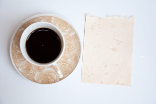 Blank paper and black coffee on white background