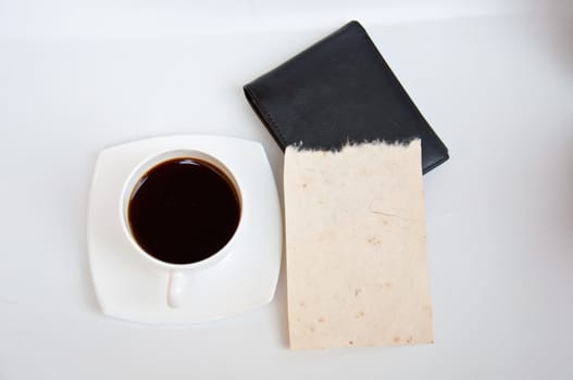 Blank paper and black coffee on white background