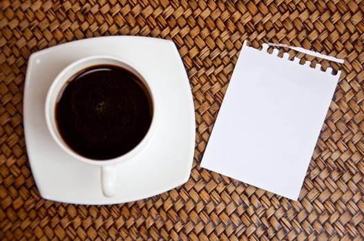 blank paper and black coffee on sedge background