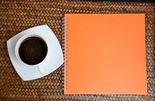 orange notebook and coffee