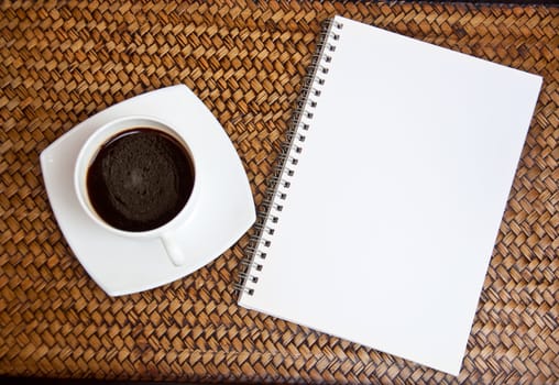 blank paper and black coffee on sedge background