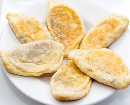 Tasty pies on a white plate