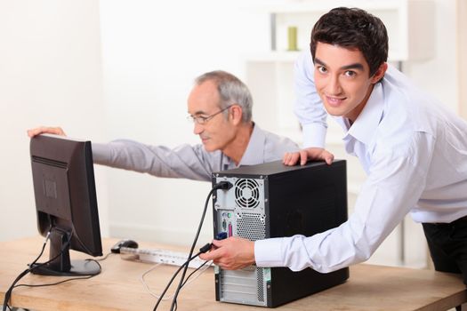 Two men with a computer