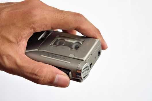 Recorder in the hand on white background