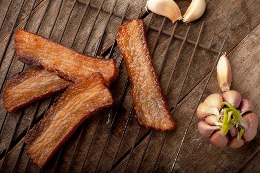 Fried fat with meet and garcic on the wooden table