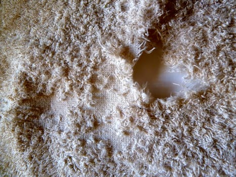 distressed white towel with a hole on white background 