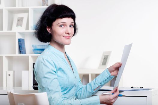 Portrait of a business woman in the office doing some paperwork