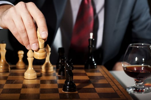 image of the businessman in a business suit plays chess