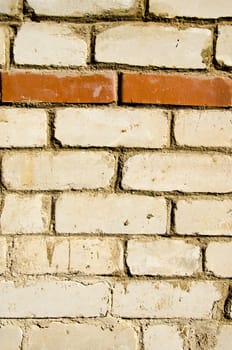 Background of white brick wall and one horizontal row of red brick. Architectural backdrop.