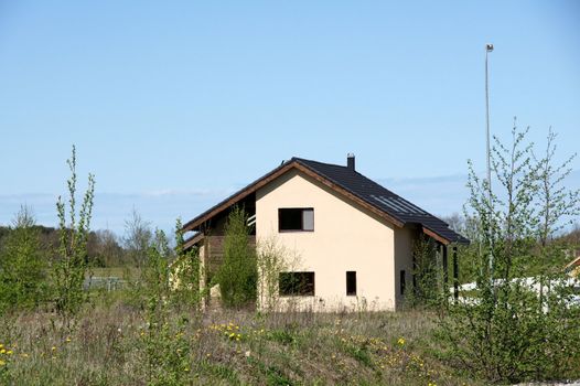 The modern house on a background of green trees