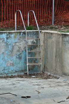 Drained swimming pool in abandoned house.