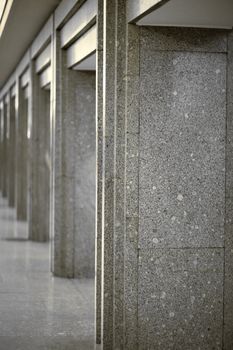 Many of columns coated with gray granite